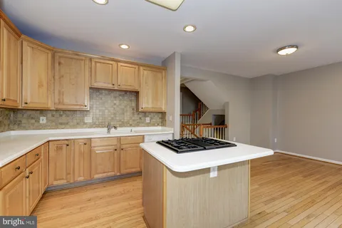 a kitchen that has a sink and a stove in it