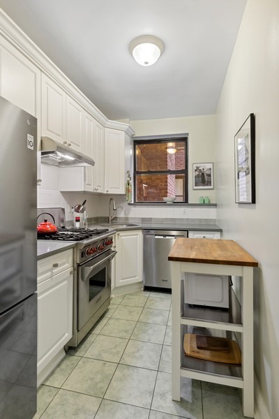 159-00 Riverside Drive West, Unit 5D Manhattan, NY 10032 - Photo 4 of 19 a kitchen with a sink cabinets and appliances