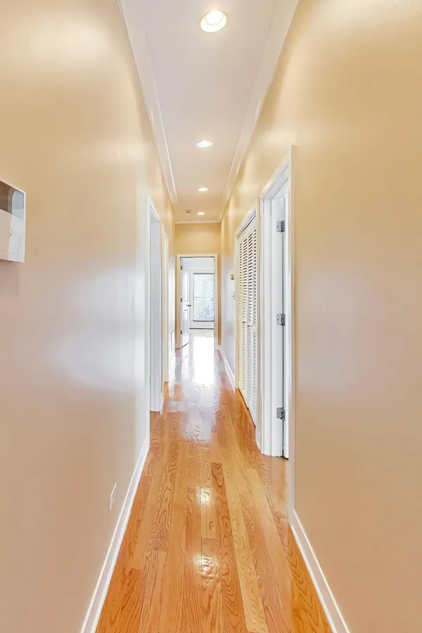 a view of a hallway with wooden floor