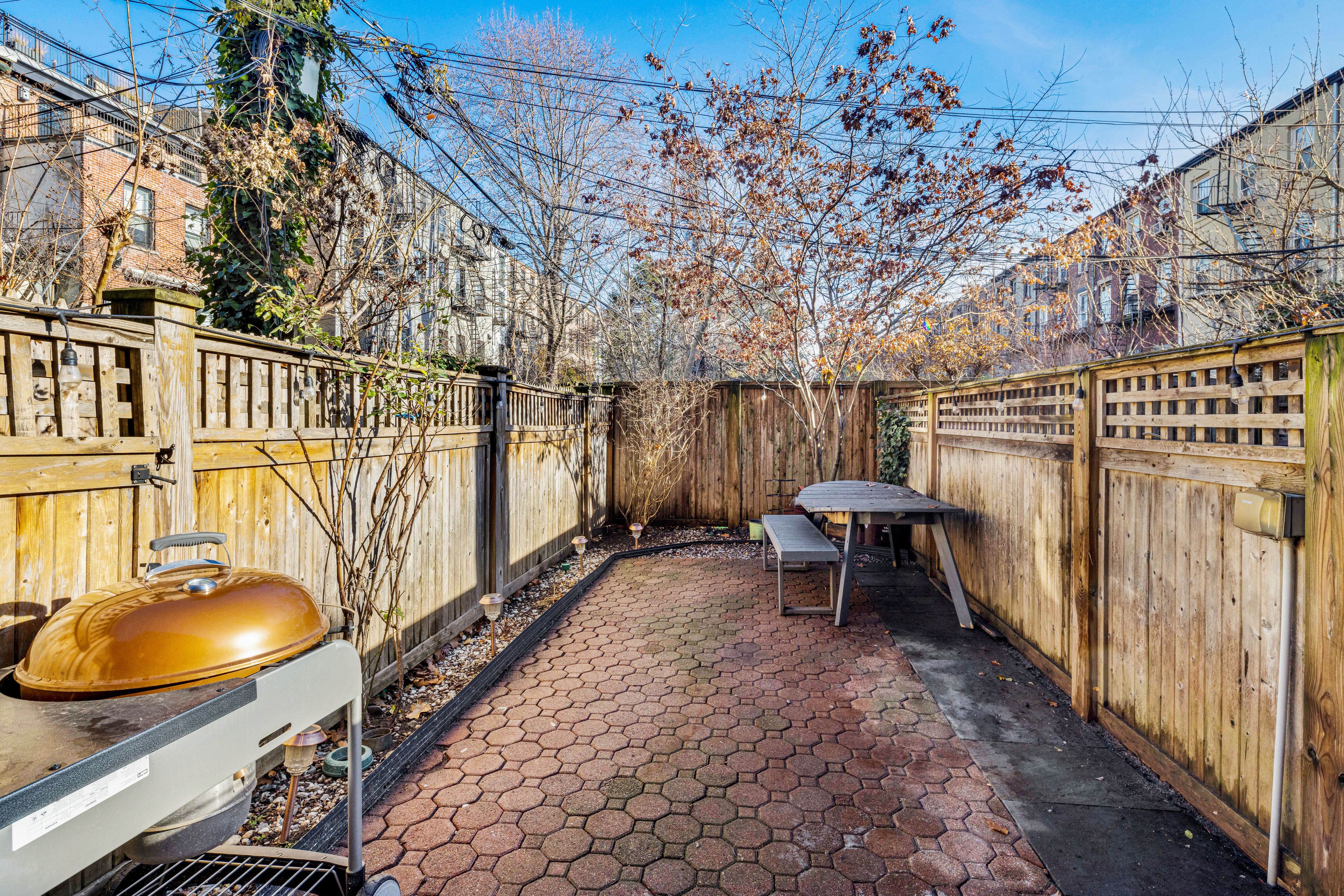159 Hoyt Street Brooklyn, NY 11217 - Photo 14 of 18 a backyard of a house with table and chairs