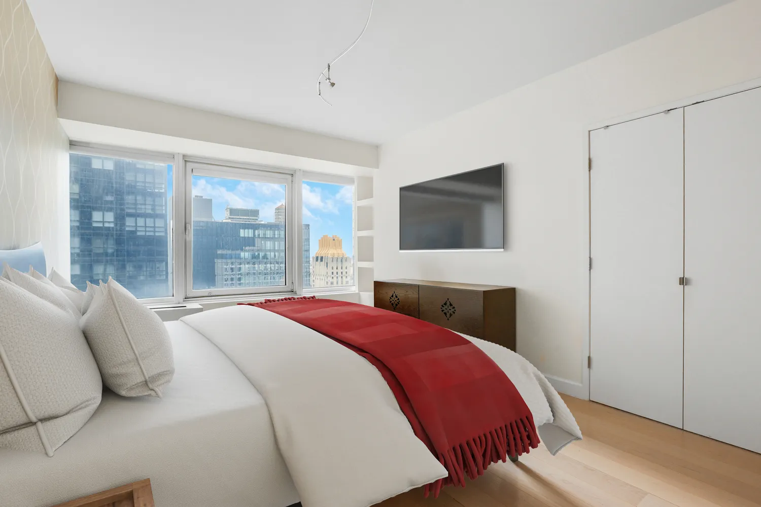 a bedroom with a bed and a flat screen tv