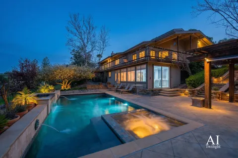 a view of a house with swimming pool yard and sitting area