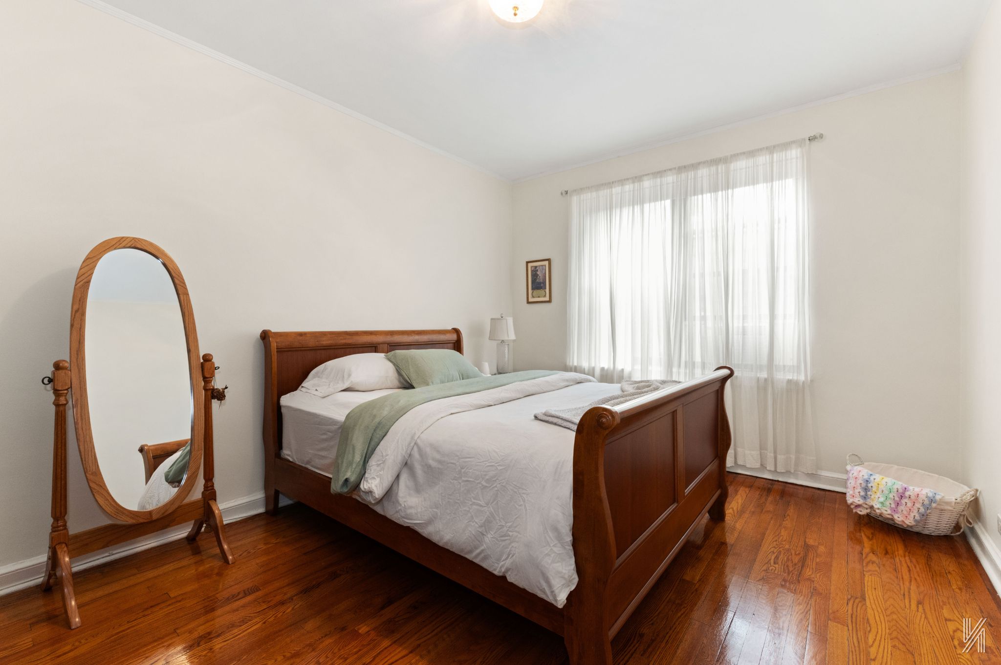 22-08 76th Street, Unit D2 Queens, NY 11370 - Photo 13 of 20 a bed sitting in a bedroom next to a window