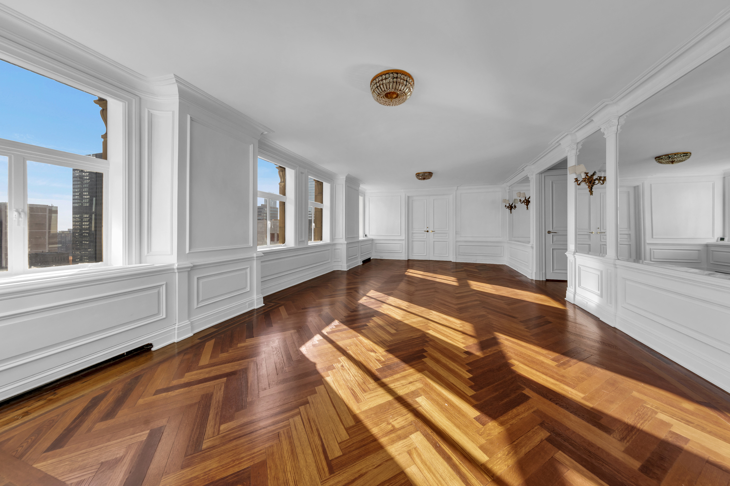 465 Park Avenue, Unit 34E Manhattan, NY 10022 - Photo 4 of 18 a view of empty room with wooden floor and fan