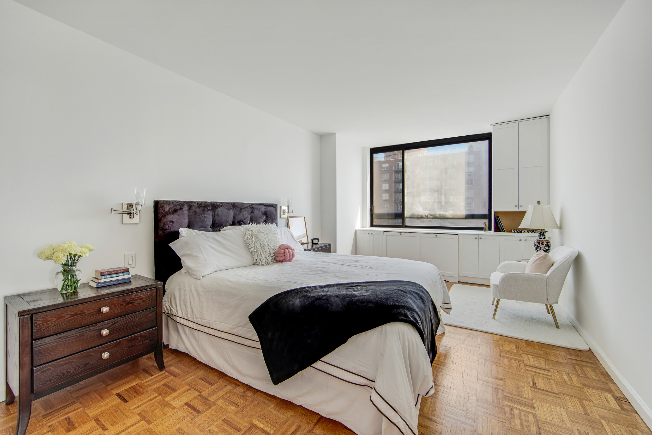 171 East 84th Street, Unit 31C Manhattan, NY 10028 - Photo 6 of 18 a bedroom with a bed and a painting on the wall