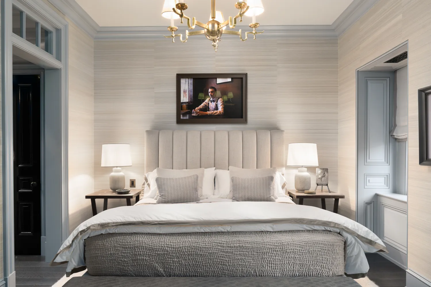 a bedroom with a bed and a chandelier