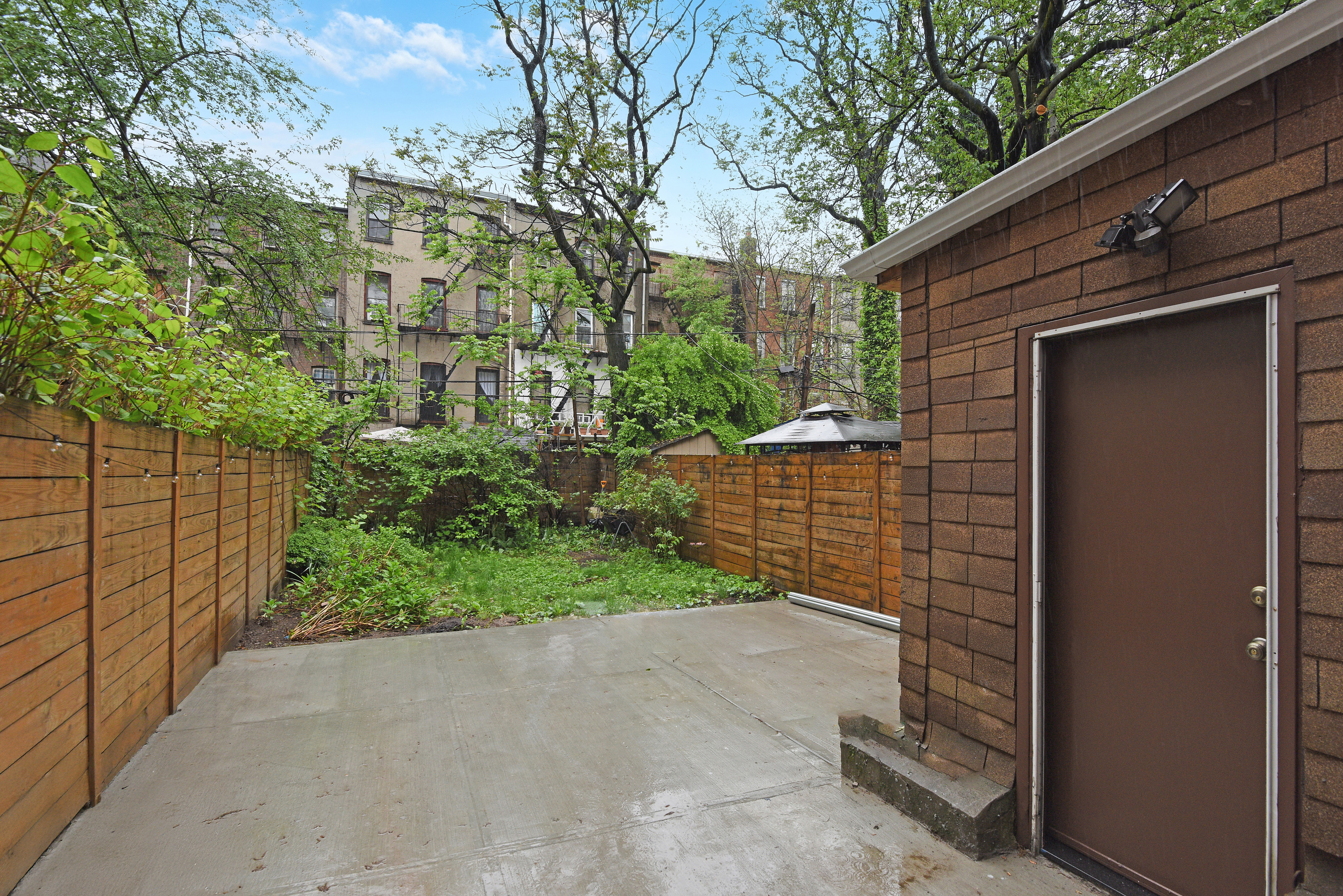 615 Willoughby Avenue, Unit 1 Brooklyn, NY 11206 - Photo 12 of 13 a backyard of a house with lots of green space
