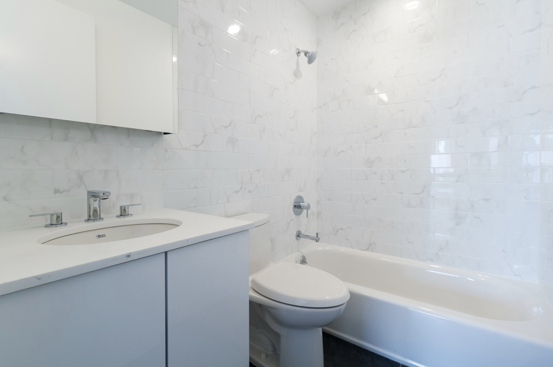 1164 Greene Avenue, Unit PHA Brooklyn, NY 11221 - Photo 4 of 13 a bathroom with a sink a toilet and bathtub