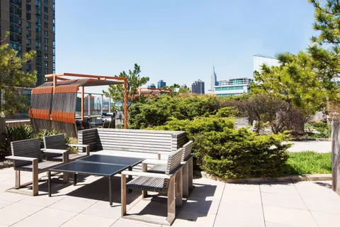 a view of a patio with table and chairs potted plants