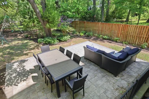 a view of a backyard with table and chairs