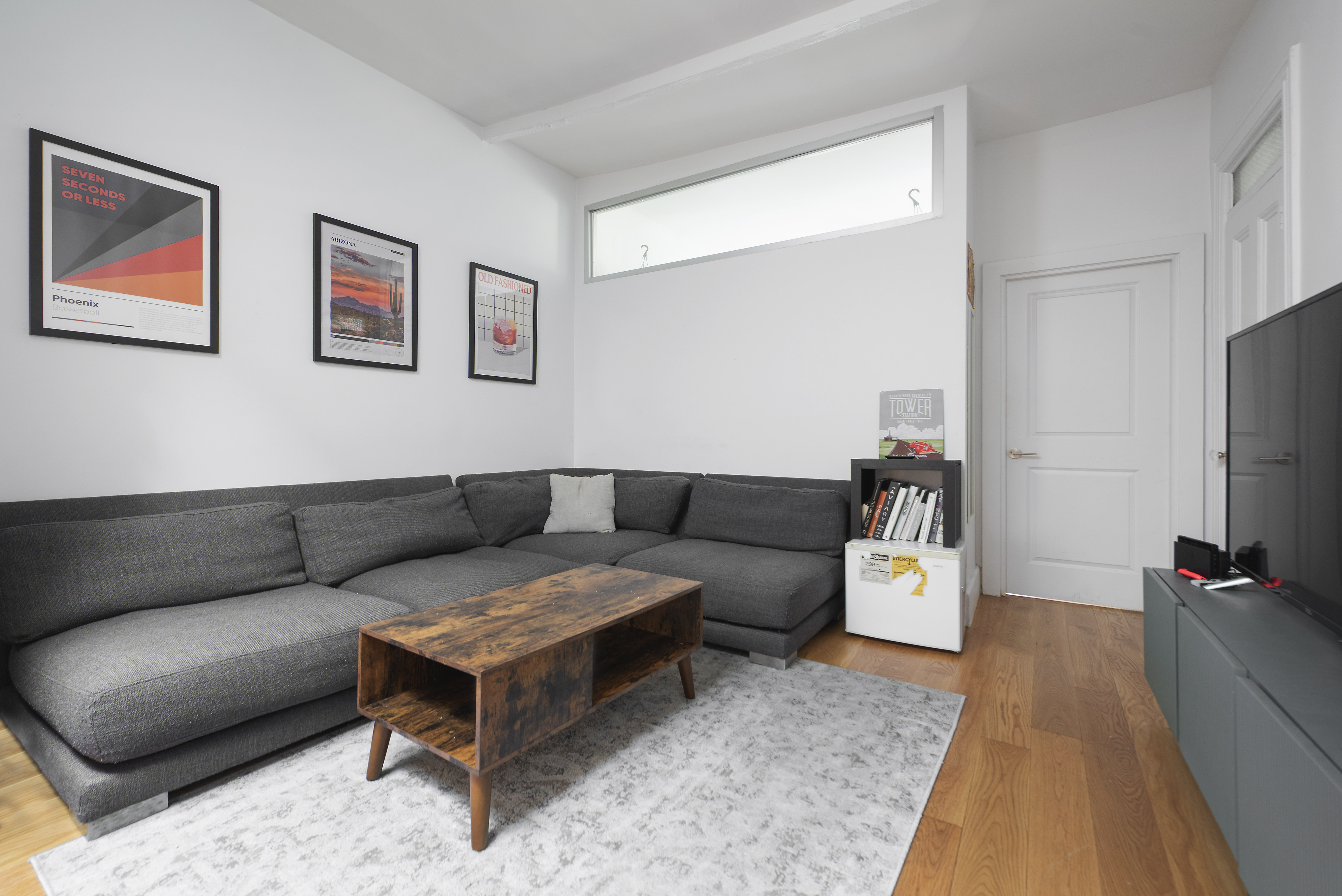 249 East Houston Street, Unit 4 Manhattan, NY 10002 - Photo 3 of 10 a living room with furniture and a flat screen tv