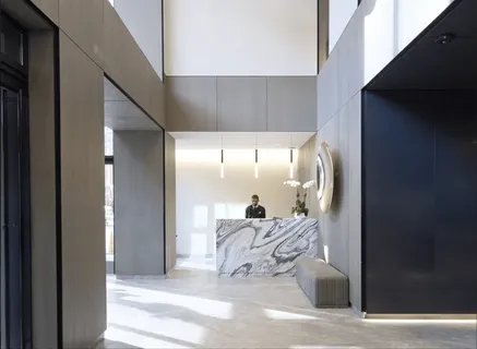 a view of a hallway to a livingroom with furniture