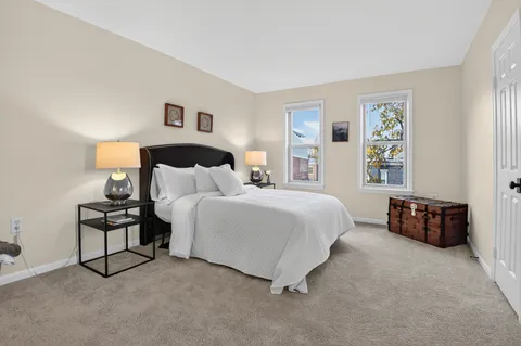 a bedroom with bed and a night stand