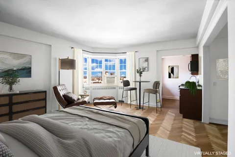 a bedroom with a bed a table and chair