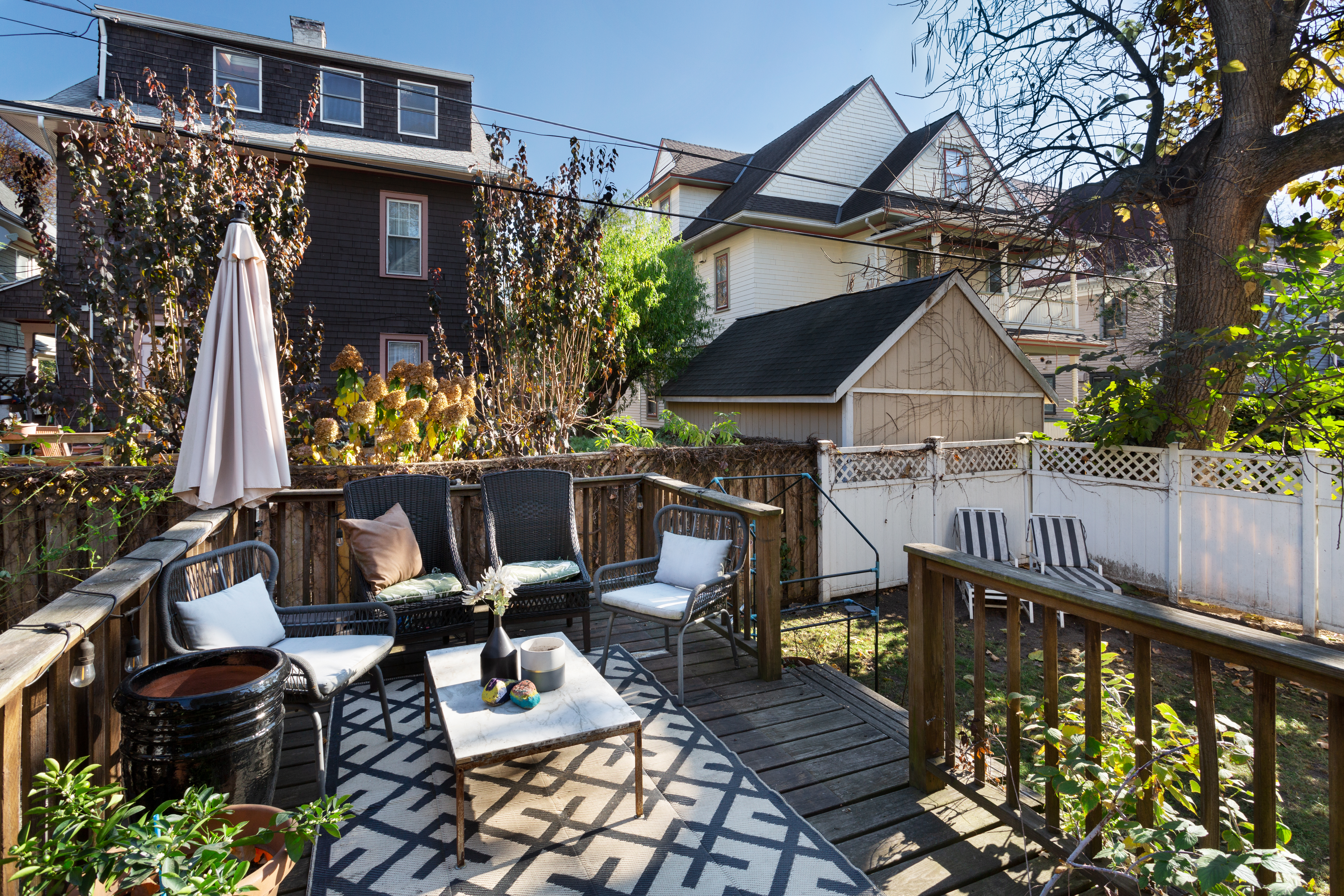 465 Argyle Road Brooklyn, NY 11218 - Photo 12 of 20 a view of balcony with chairs and wooden fence