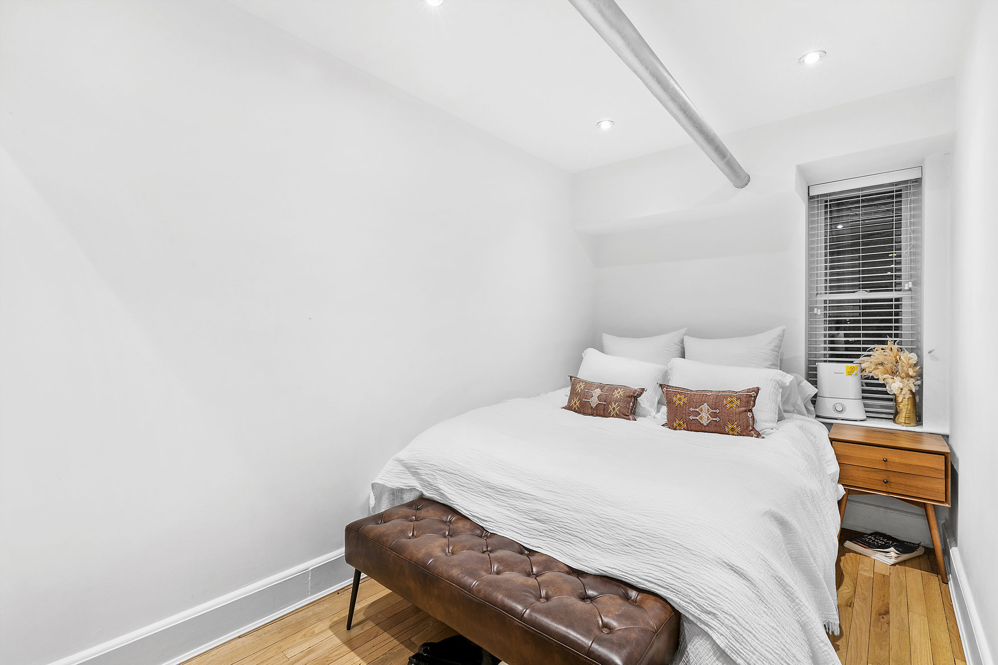 140 West 10th Street, Unit BTW Manhattan, NY 10014 - Photo 4 of 8 a bedroom with a bed and a table in it