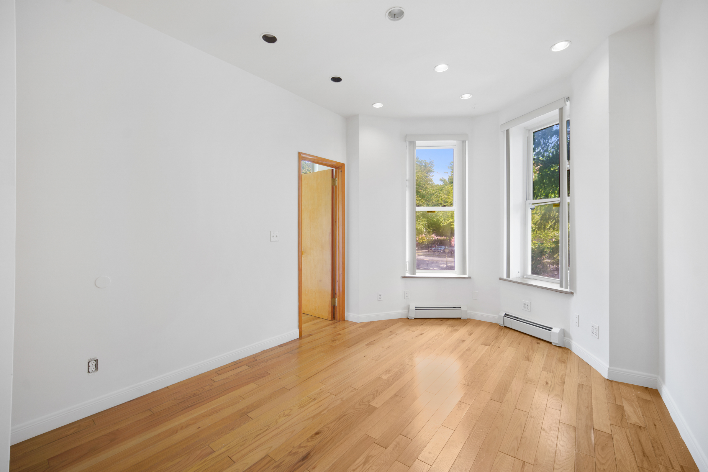 614 Eastern Parkway, Unit 2 Brooklyn, NY 11225 - Photo 3 of 6 a view of empty room with wooden floor and fan