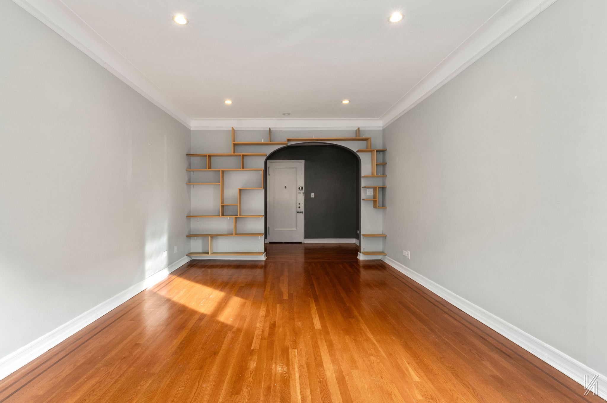 25-40 31st Avenue, Unit 6E Queens, NY 11106 - Photo 5 of 15 a view of empty room with wooden floor and fan
