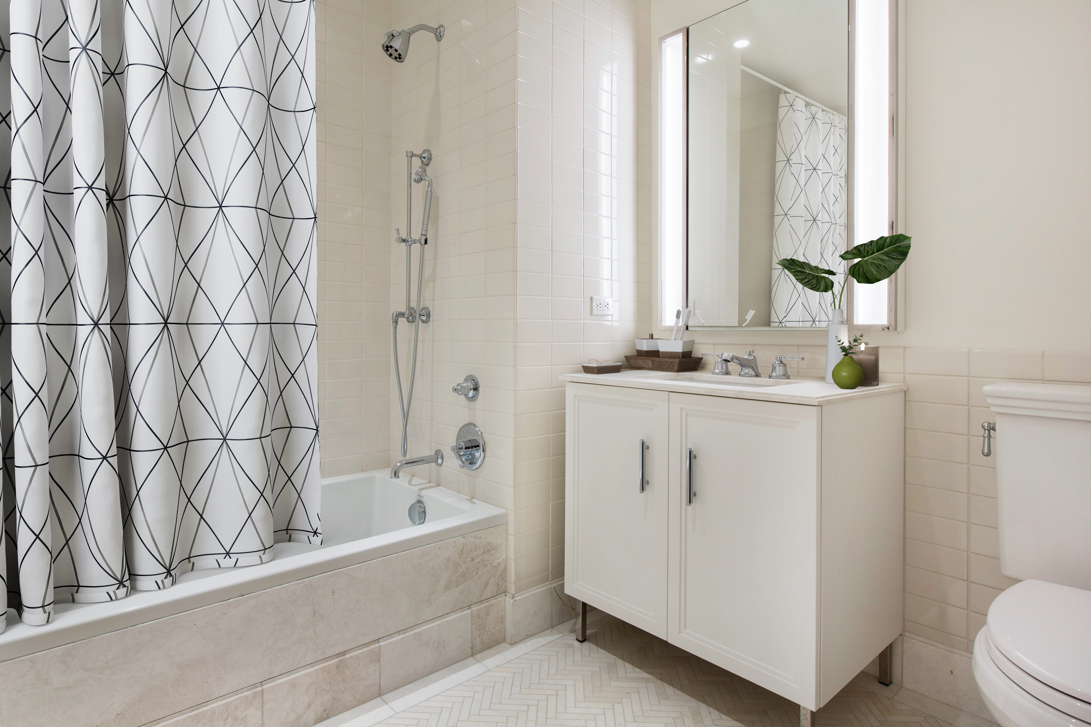 100 Barclay Street, Unit 17H Manhattan, NY 10007 - Photo 9 of 11 a bathroom with a bathtub sink and toilet