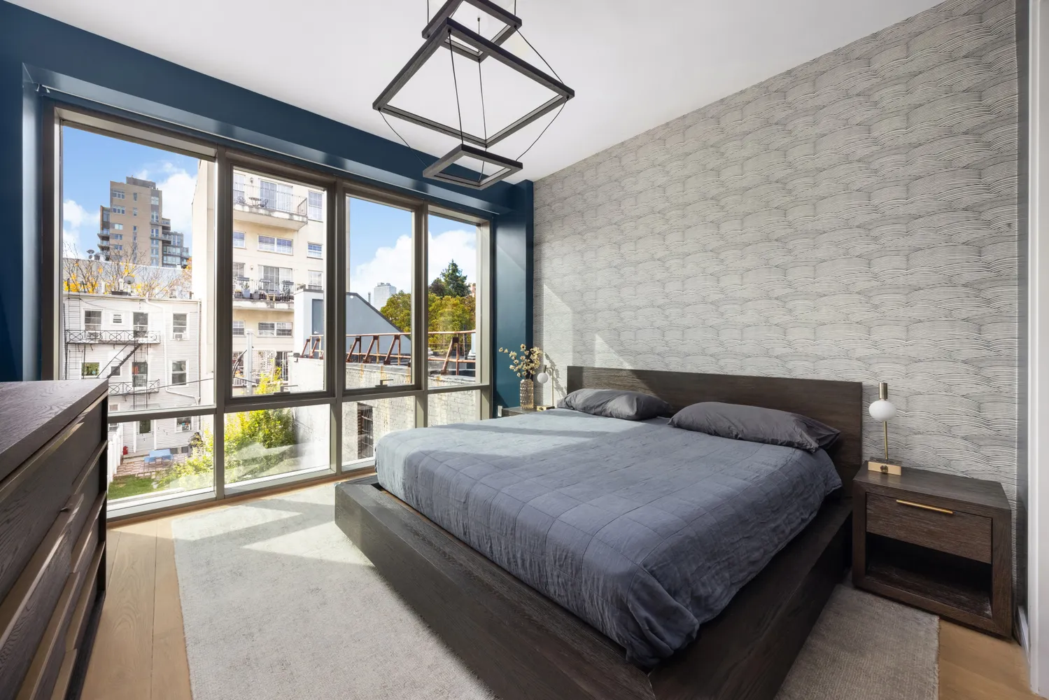 a bedroom with a large bed and a large window