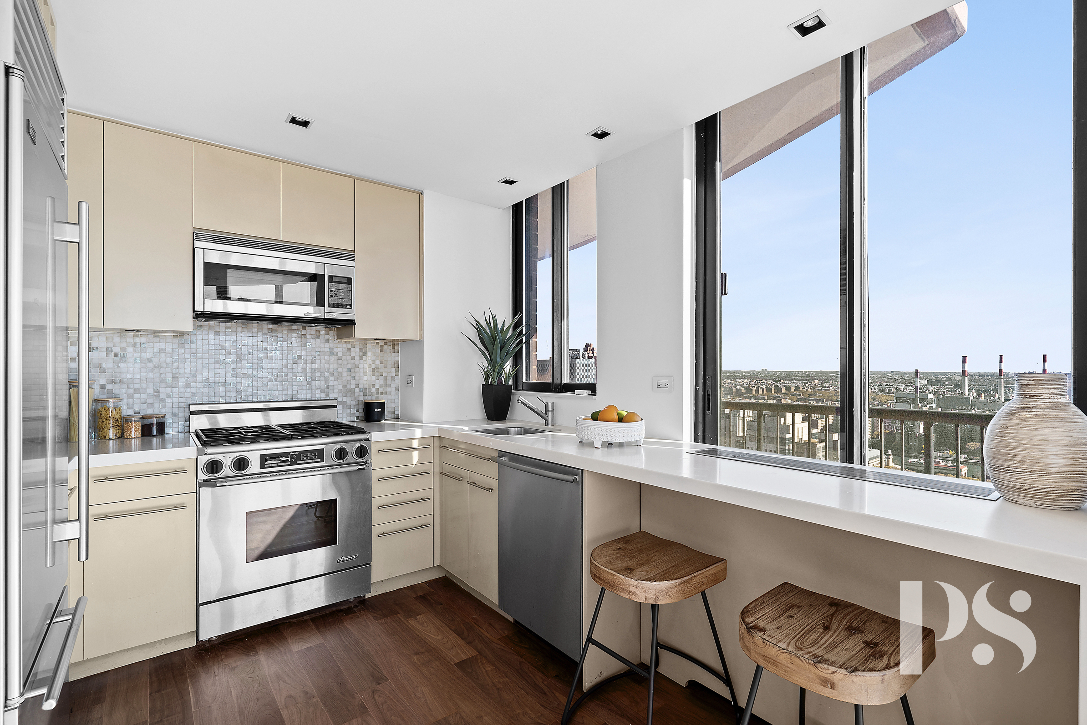 304 East 65th Street, Unit 39C Manhattan, NY 10065 - Photo 4 of 10 a kitchen with a stove a sink and a wooden floor