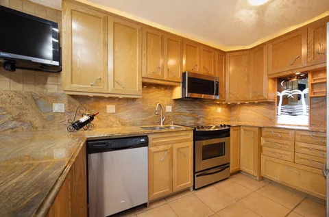 a view of a hallway with a chandelier fan