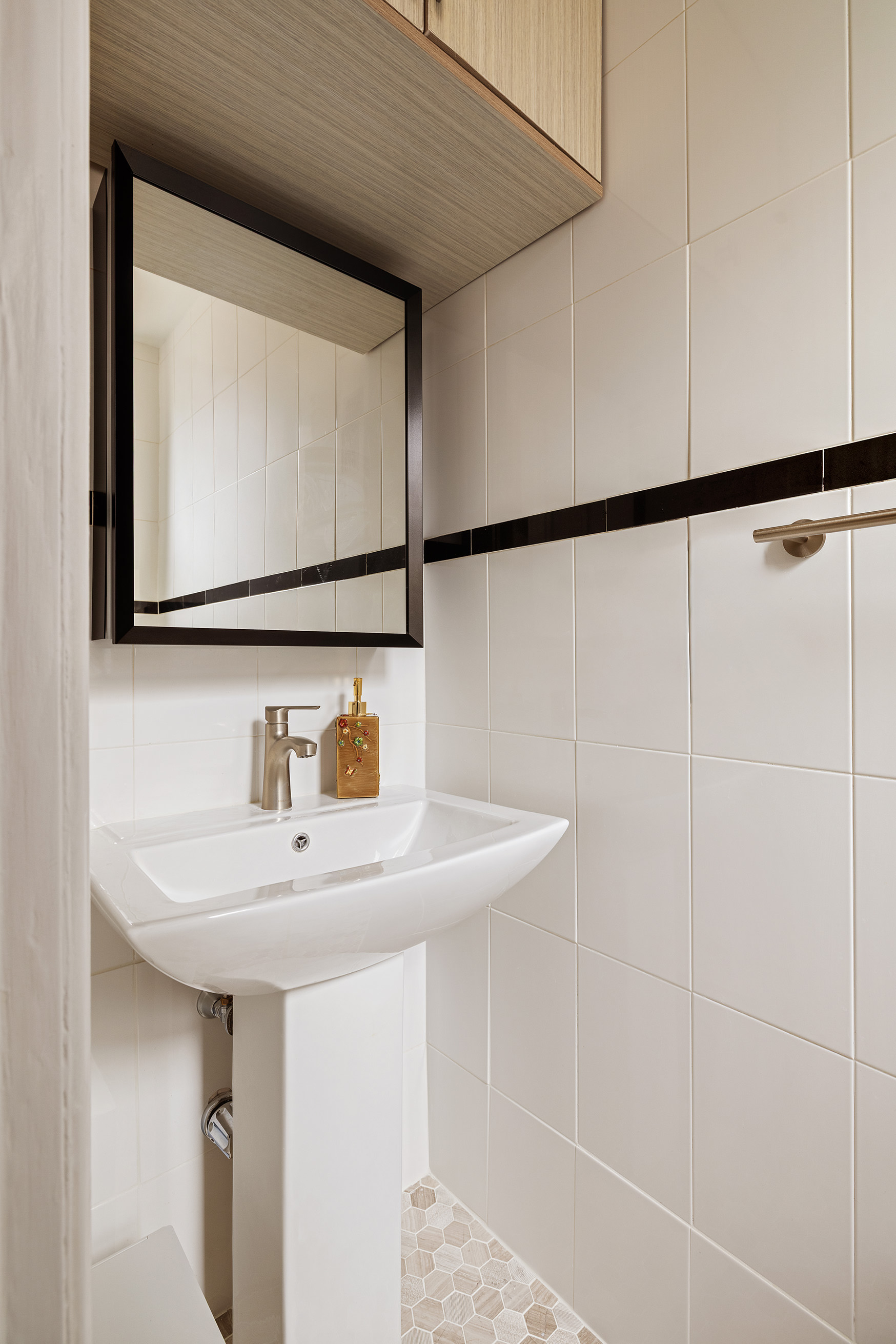 119 East 84th Street, Unit 9C Manhattan, NY 10028 - Photo 8 of 10 a bathroom with a sink and a mirror