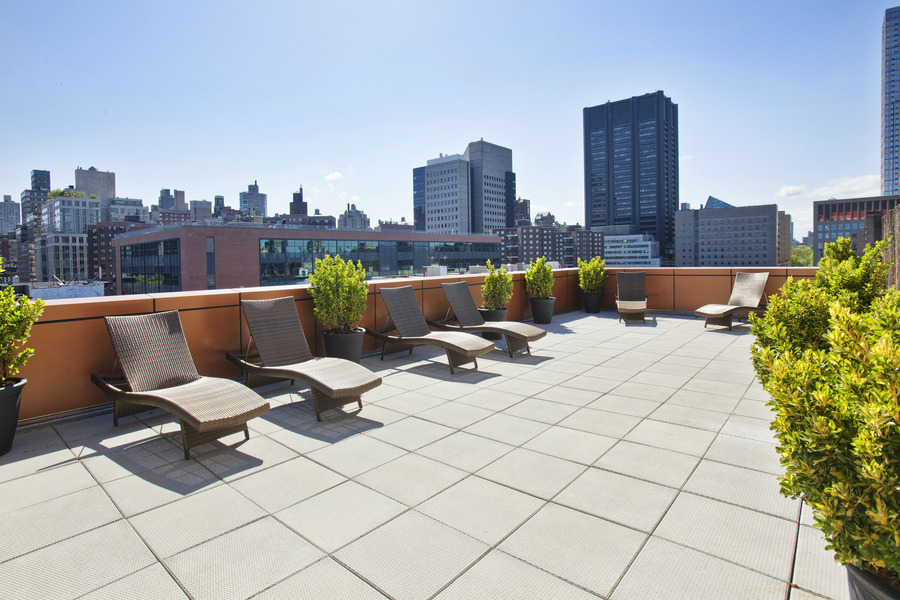 1595 Lexington Avenue, Unit 6E Manhattan, NY 10029 - Photo 8 of 13 a view of roof deck with seating space and trees