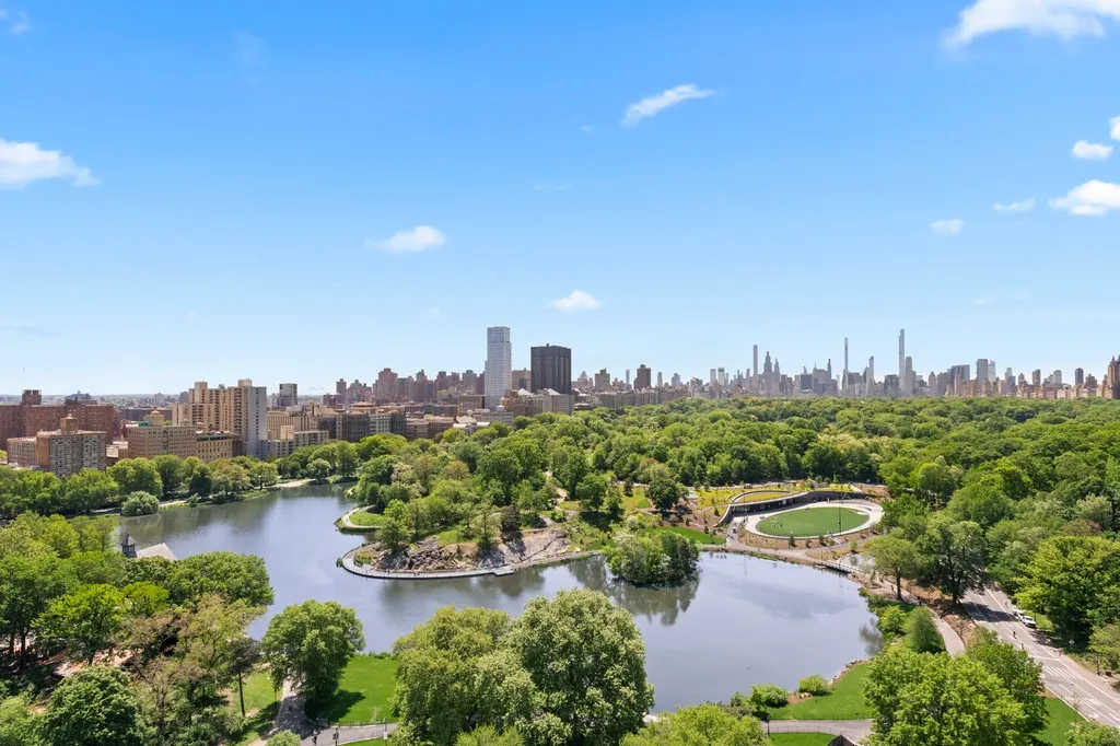 an aerial view of a city with lots of residential buildings lake and ocean view
