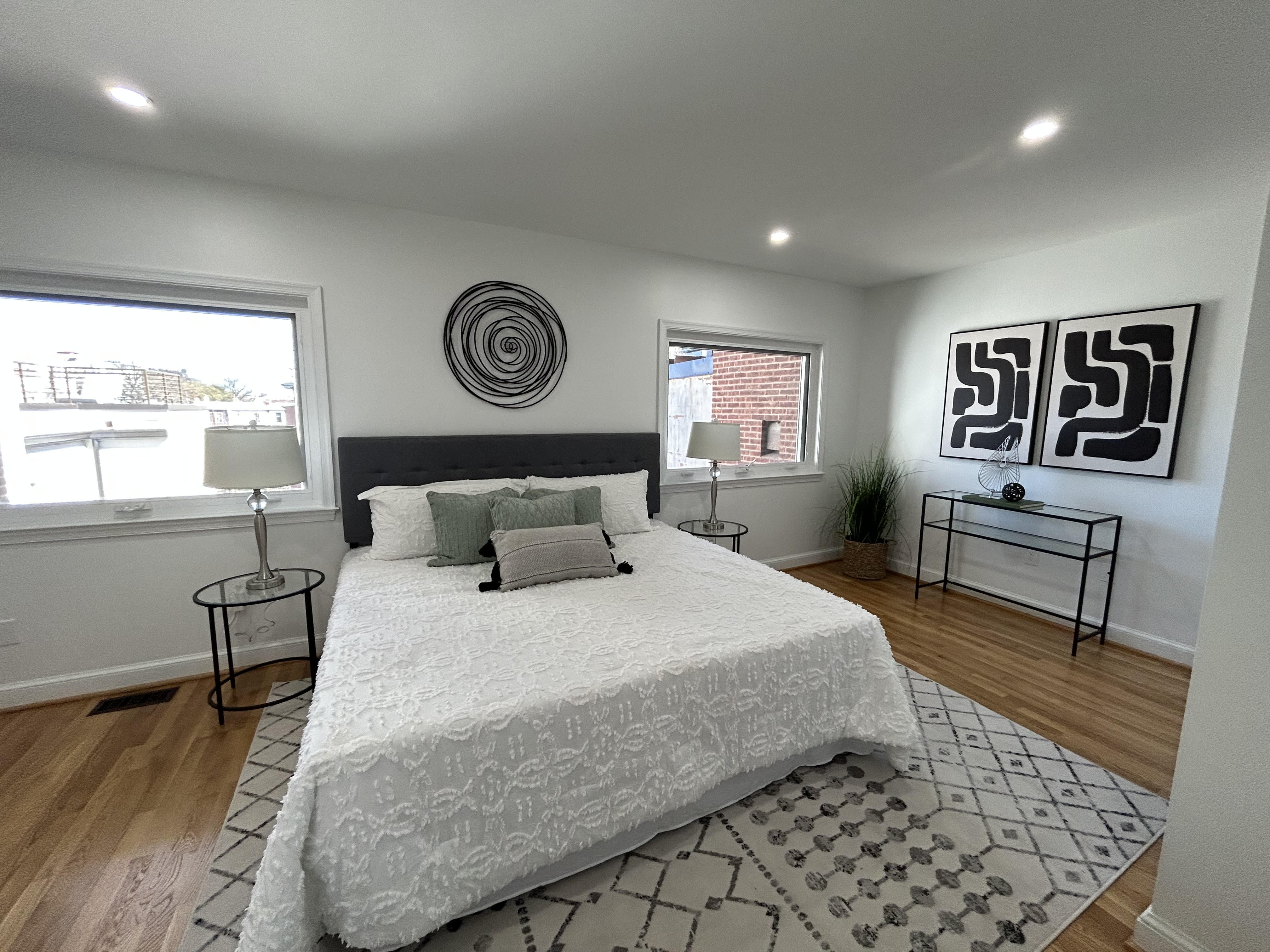 1823 16th Street Northwest, Unit 2 Washington, DC 20009 - Photo 7 of 19 a bedroom with a bed and a table with wooden floor