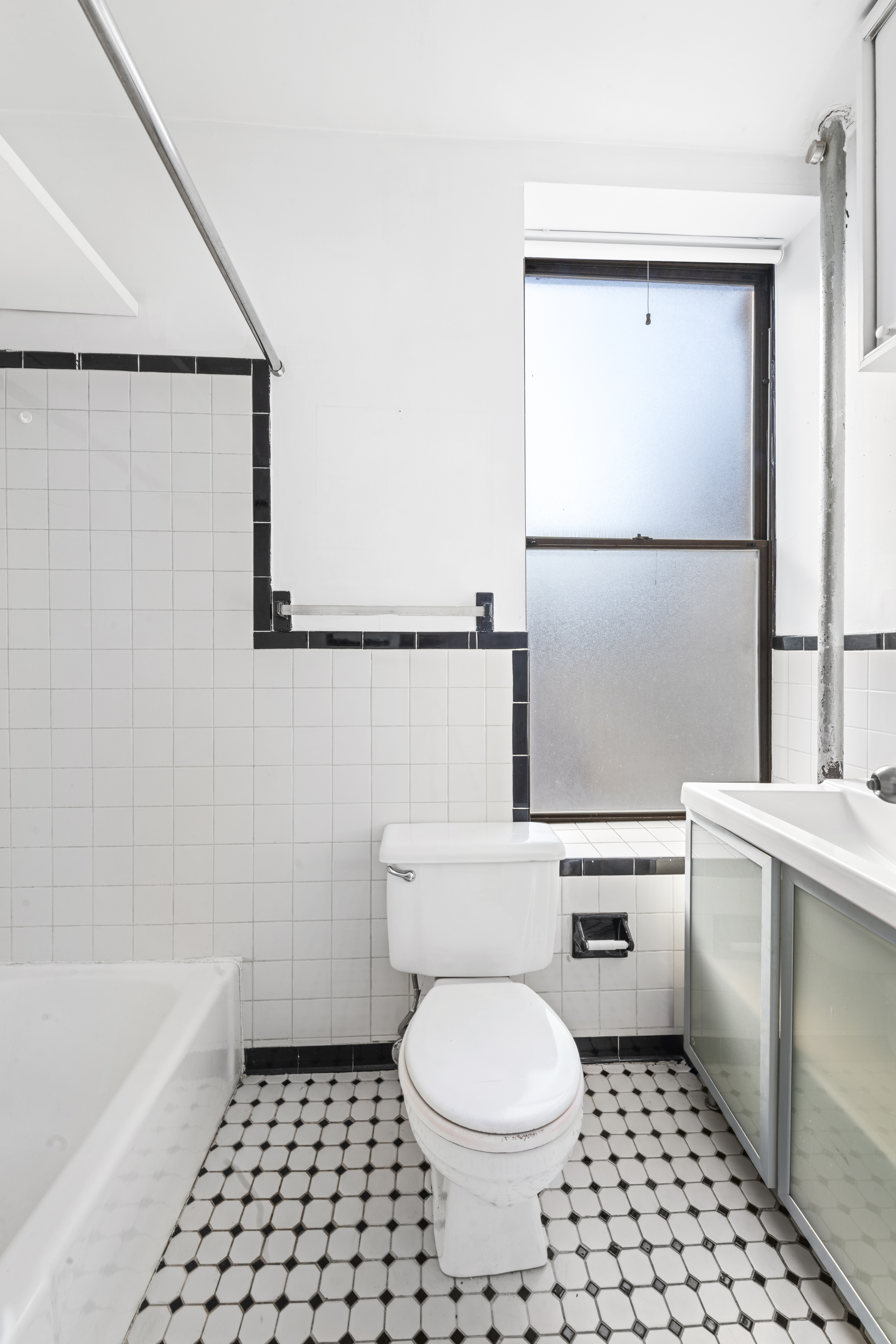 214 Mulberry Street, Unit 6B Manhattan, NY 10012 - Photo 8 of 12 a bathroom with a toilet a sink and a bathtub