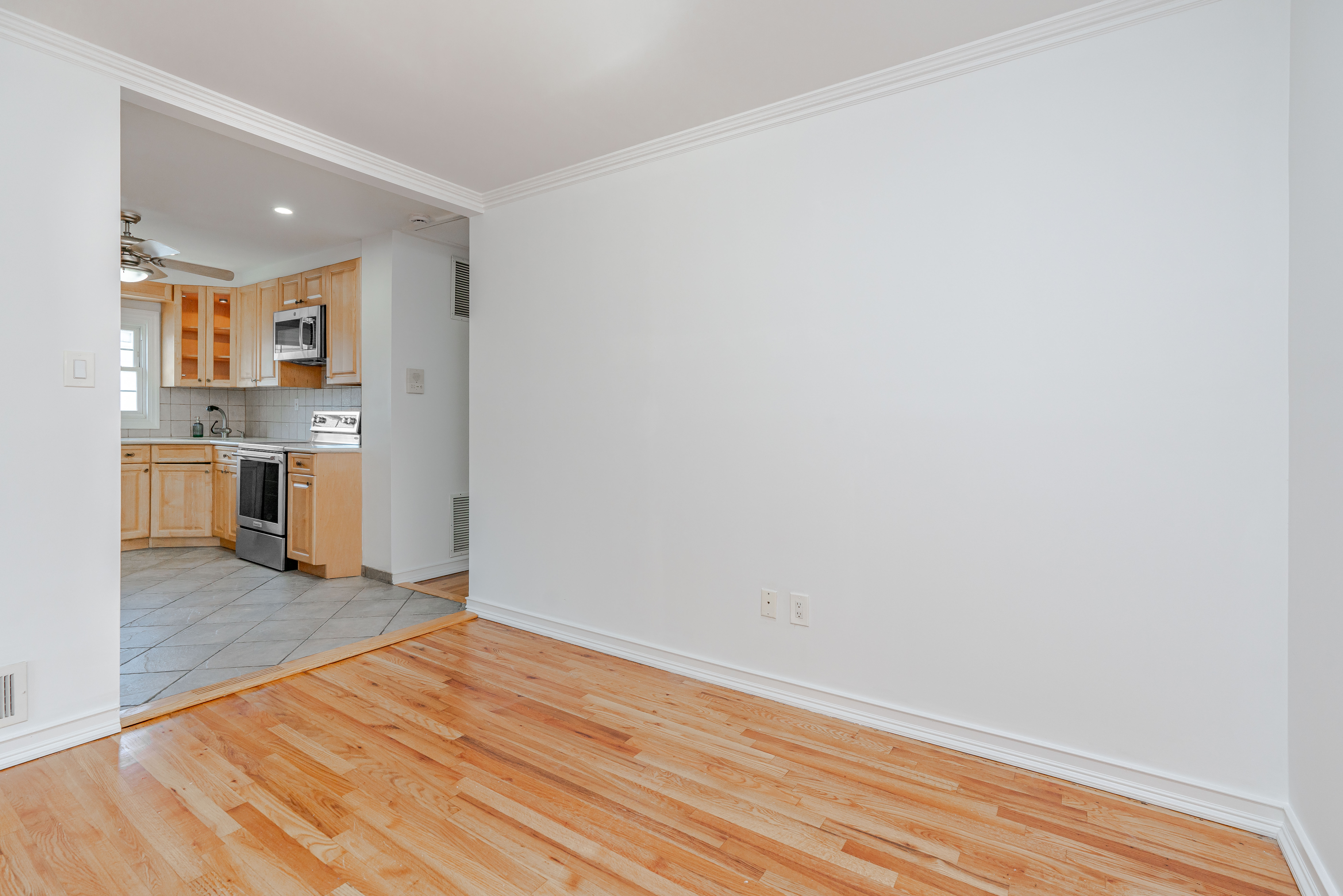 15-80 209th Street, Unit 2 Queens, NY 11360 - Photo 4 of 11 a view of kitchen and wooden floor