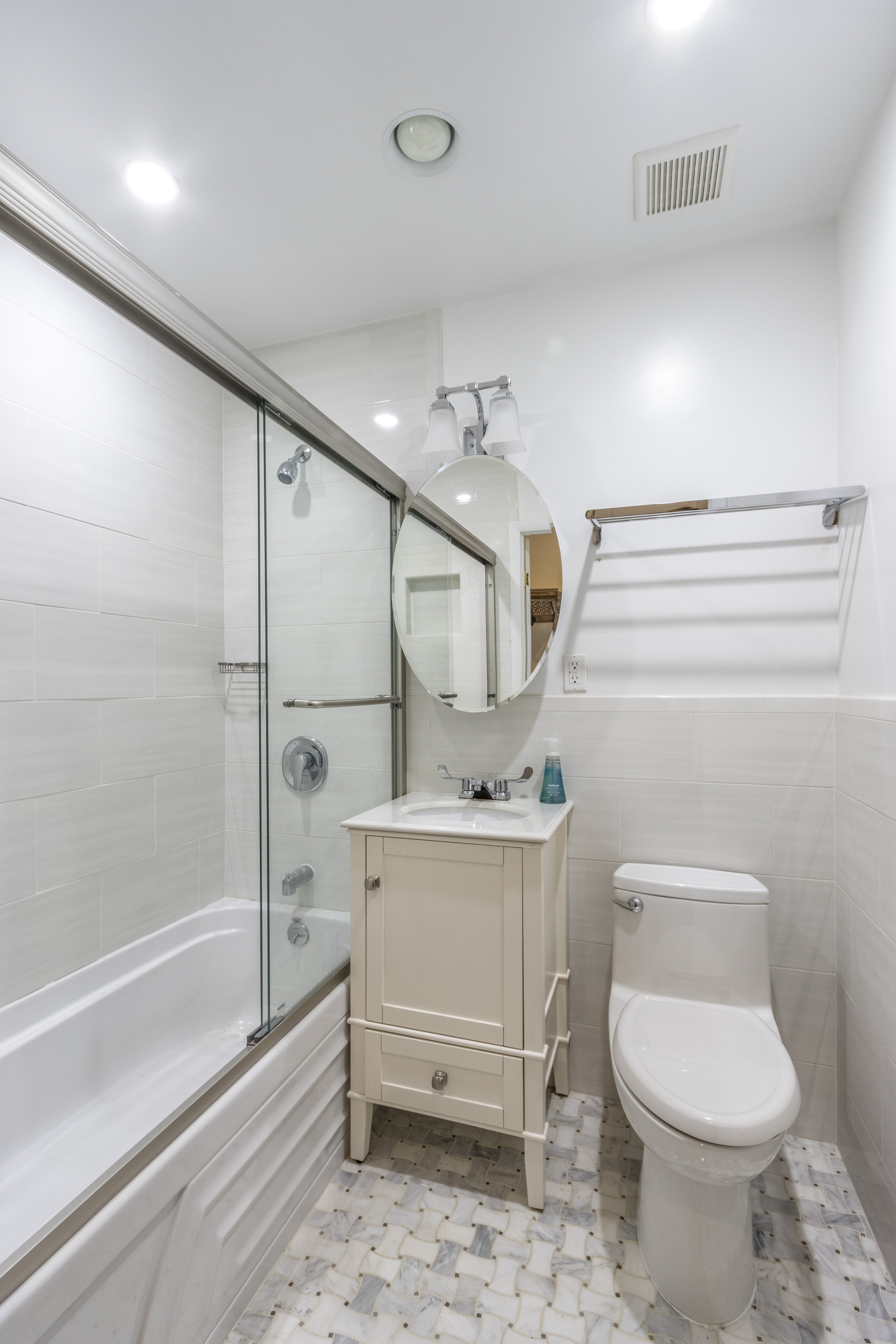 160 East 74th Street, Unit 3 Manhattan, NY 10021 - Photo 8 of 12 a bathroom with a sink a toilet and shower