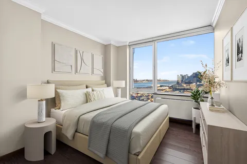 a bedroom with a bed and a large window