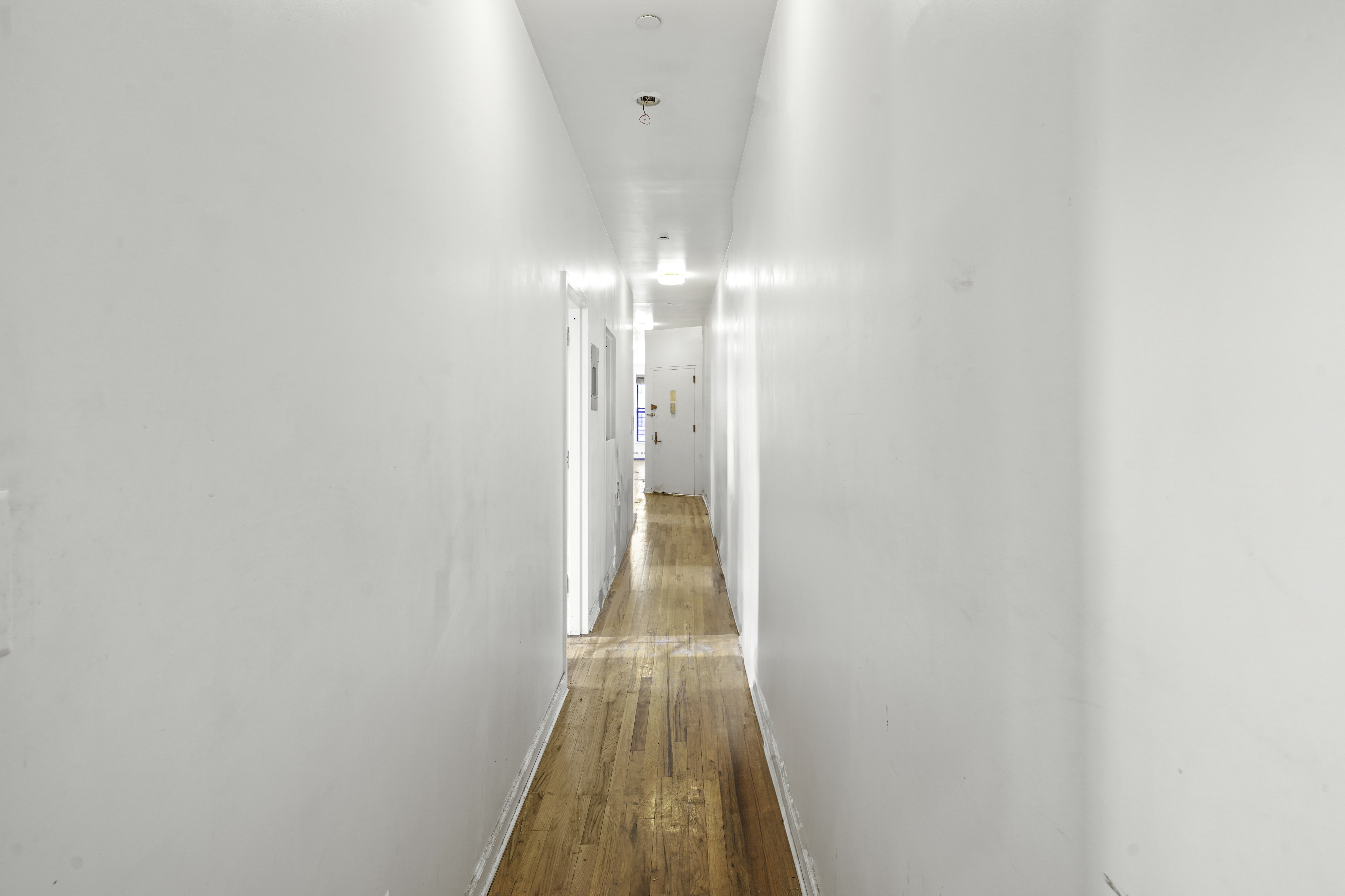 163 Lenox Avenue, Unit 5A Manhattan, NY 10026 - Photo 7 of 16 a view of a hallway with wooden floor