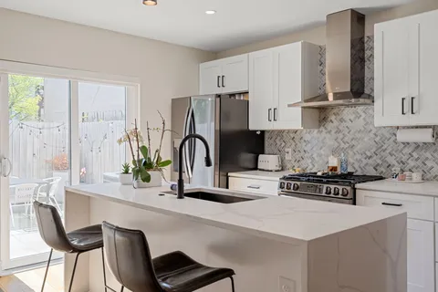 a kitchen with sink refrigerator and microwave
