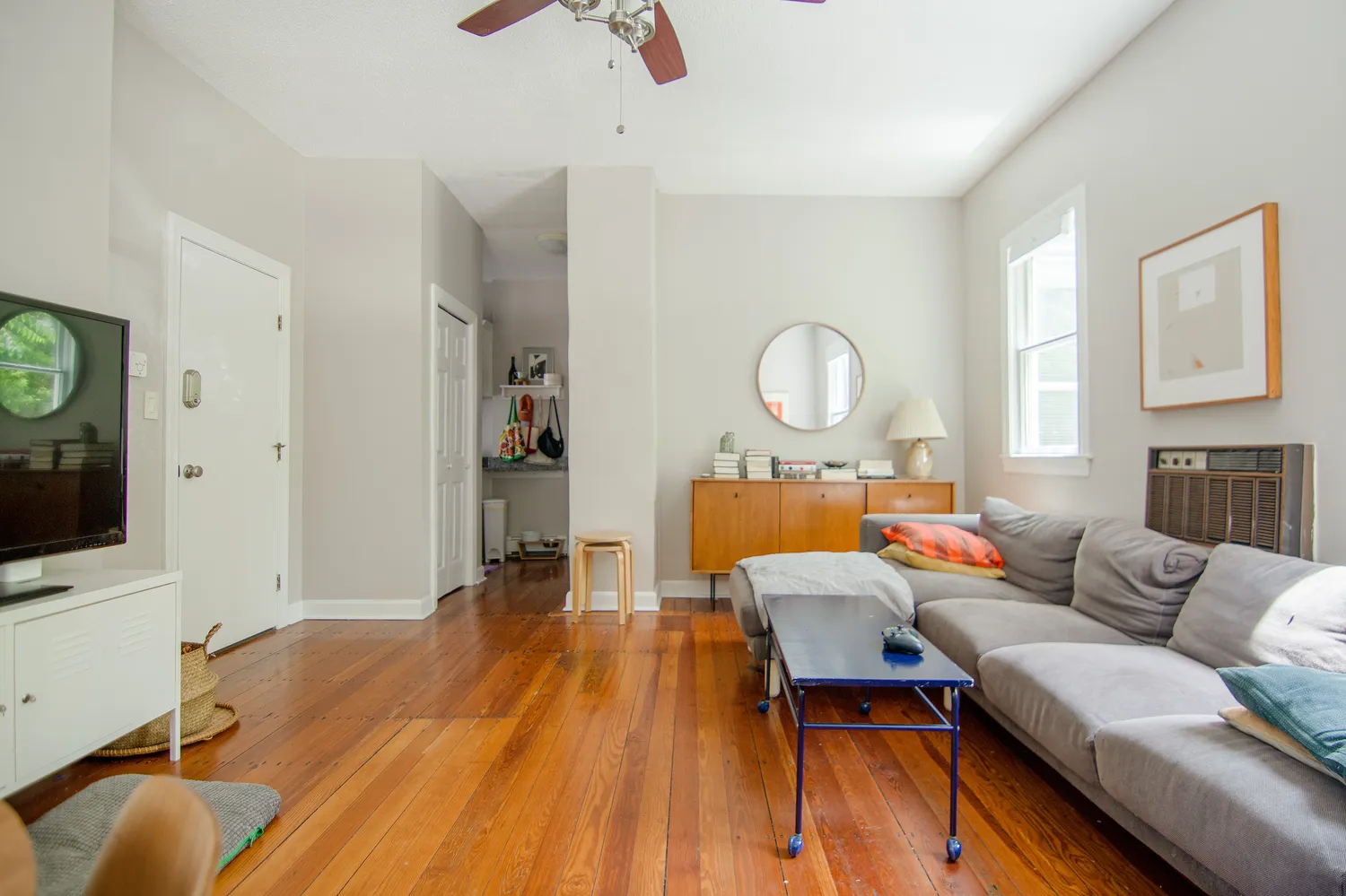 a living room with furniture and a flat screen tv