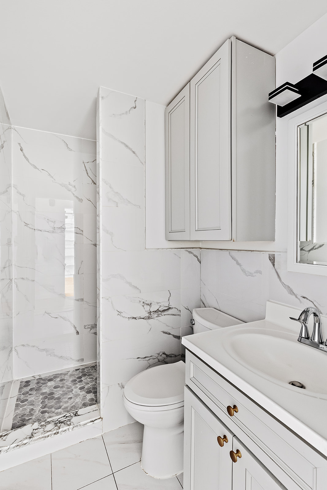 126 Waverly Place, Unit 2F Manhattan, NY 10011 - Photo 5 of 11 a bathroom with a sink a toilet and shower