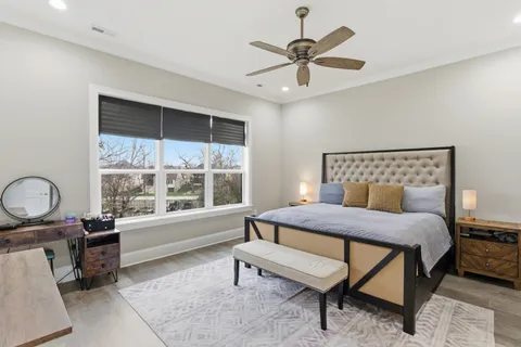 a bedroom with a bed and a large window