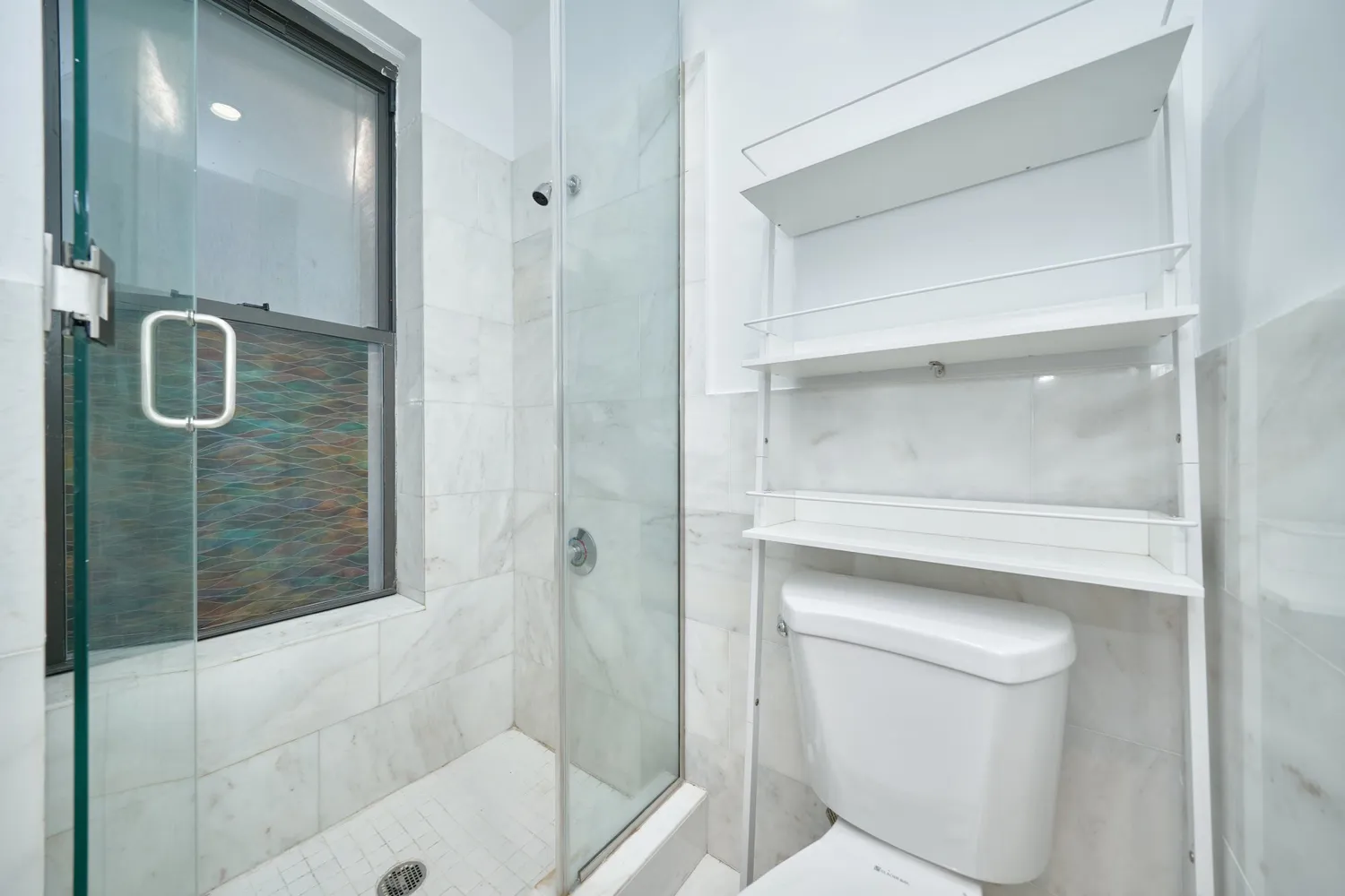 a bathroom with a shower and toilet