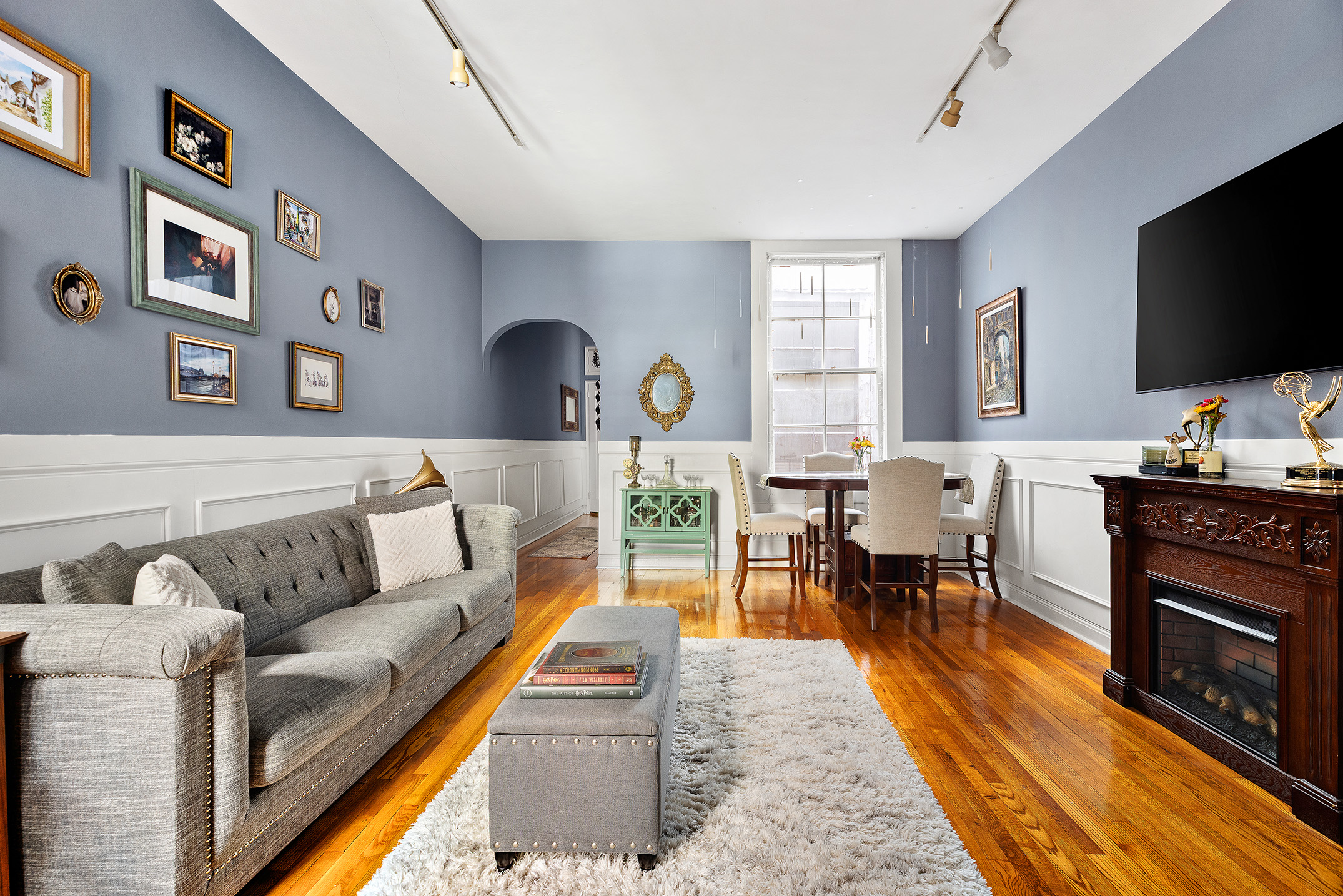 175 East 93rd Street, Unit 3B Manhattan, NY 10128 - Photo 3 of 12 a living room with furniture a flat screen tv and kitchen view