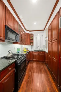 a kitchen with stainless steel appliances granite countertop a stove a sink and a refrigerator