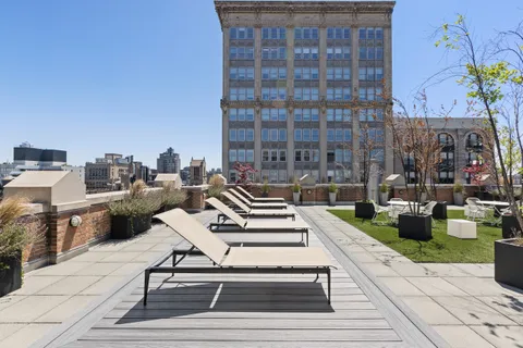 a view of a patio with table and chairs and potted plants
