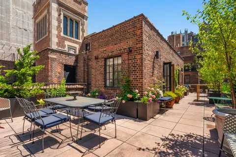 a view of a patio with couches table and chairs and potted plants