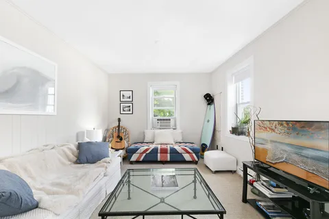 a kitchen with stainless steel appliances granite countertop a window and white cabinets
