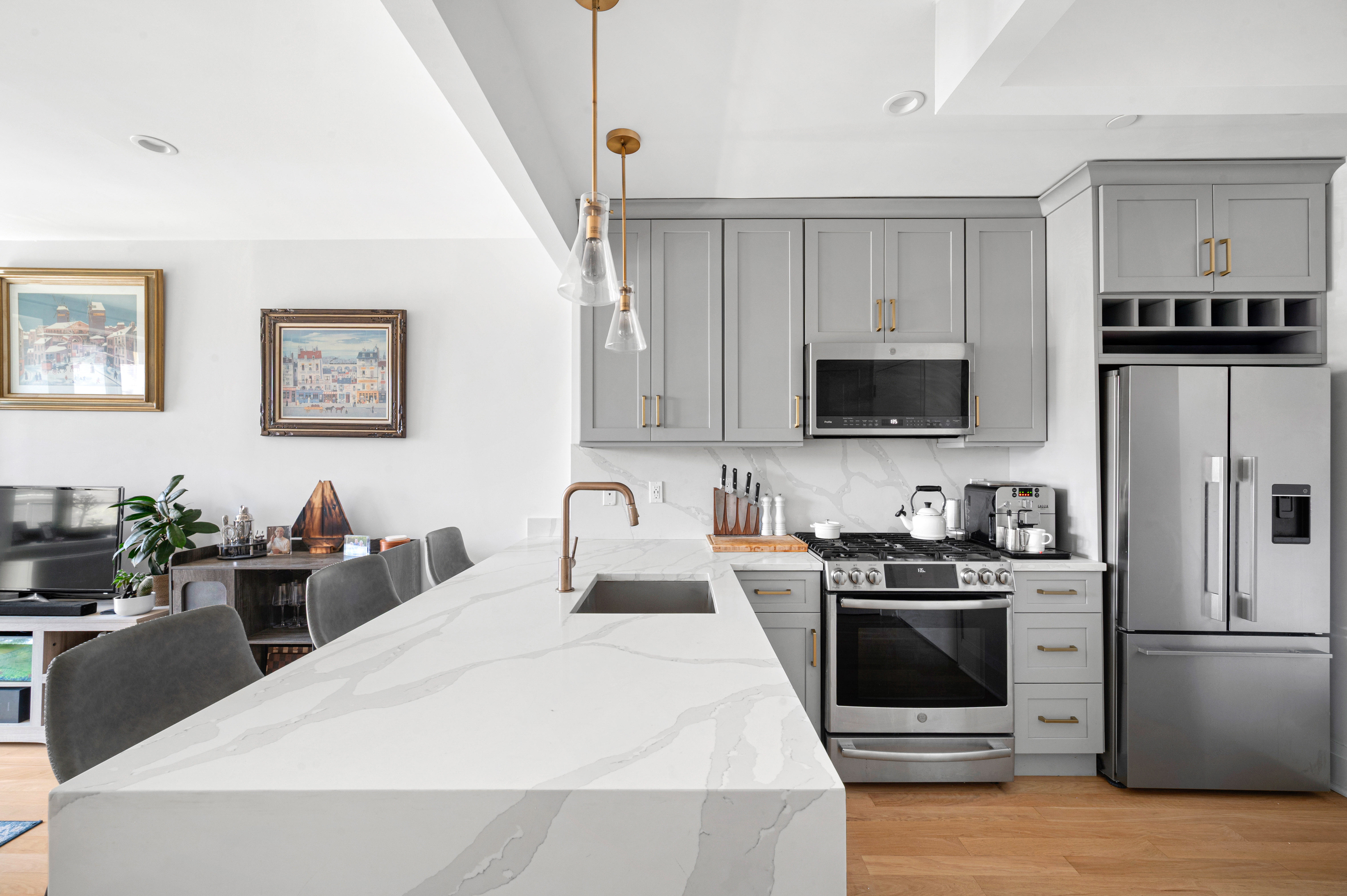 23-43 31st Road, Unit 3C Queens, NY 11106 - Photo 2 of 10 a kitchen with stainless steel appliances a white refrigerator a stove a sink a microwave and a refrigerator
