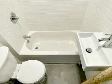 a bathroom with a tub and a sink