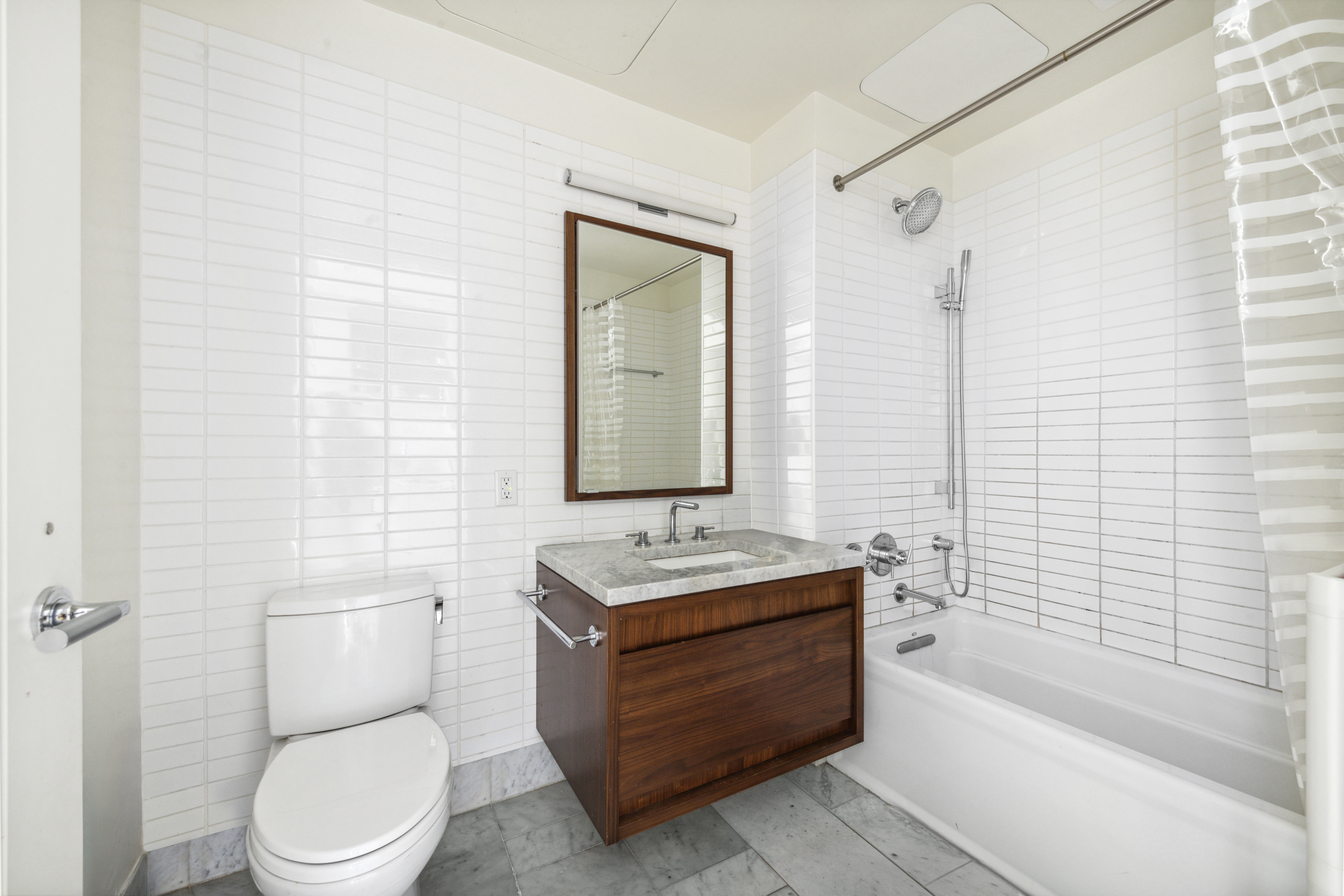 550 Vanderbilt Avenue, Unit 611 Brooklyn, NY 11238 - Photo 3 of 8 a bathroom with a toilet a sink and bathtub