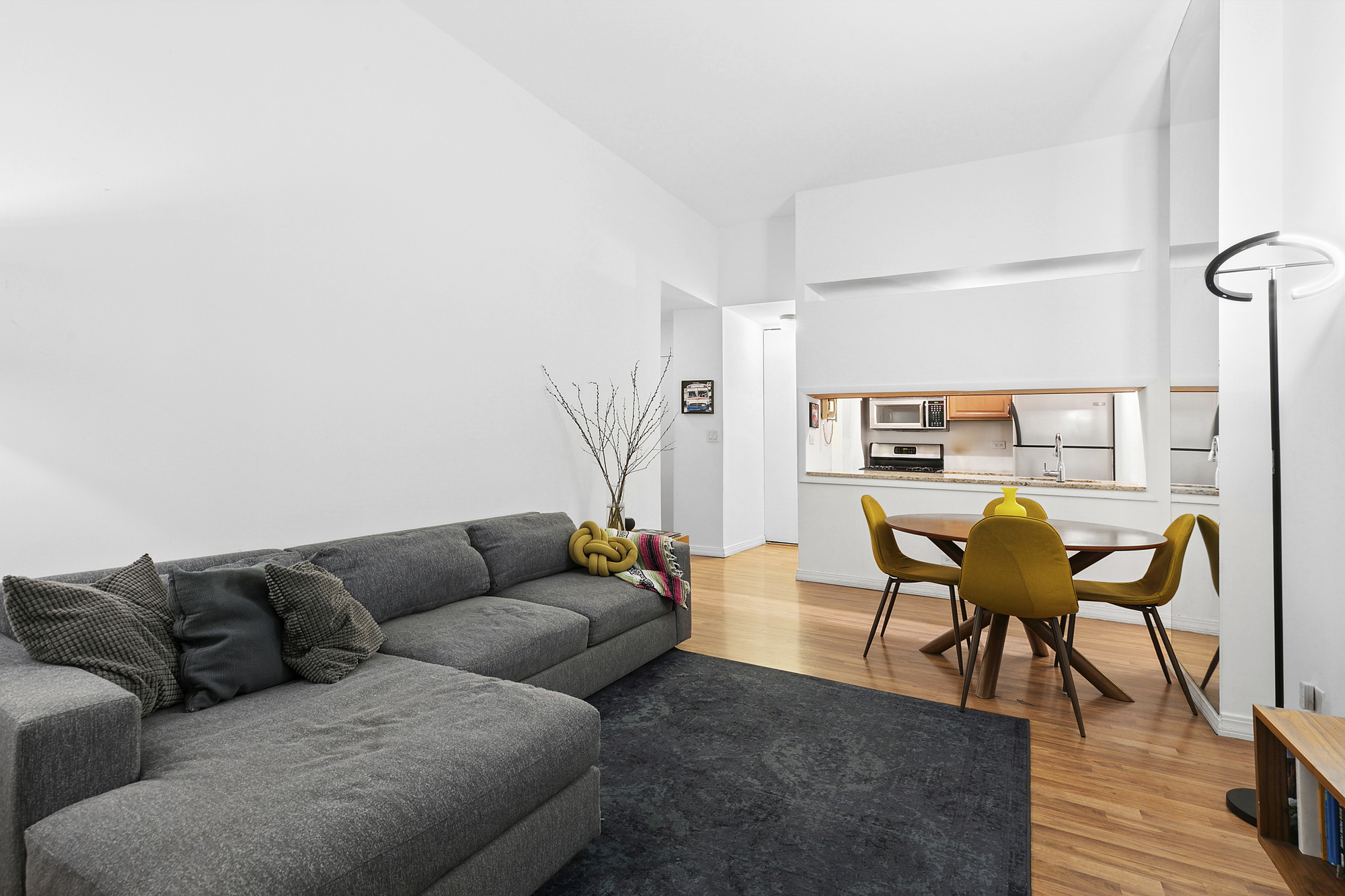 377 Rector Place, Unit 1D Manhattan, NY 10280 - Photo 2 of 6 a living room with furniture and a wooden floor