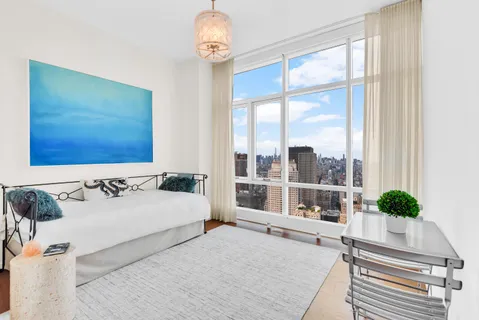 a spacious bedroom with a bed and a window